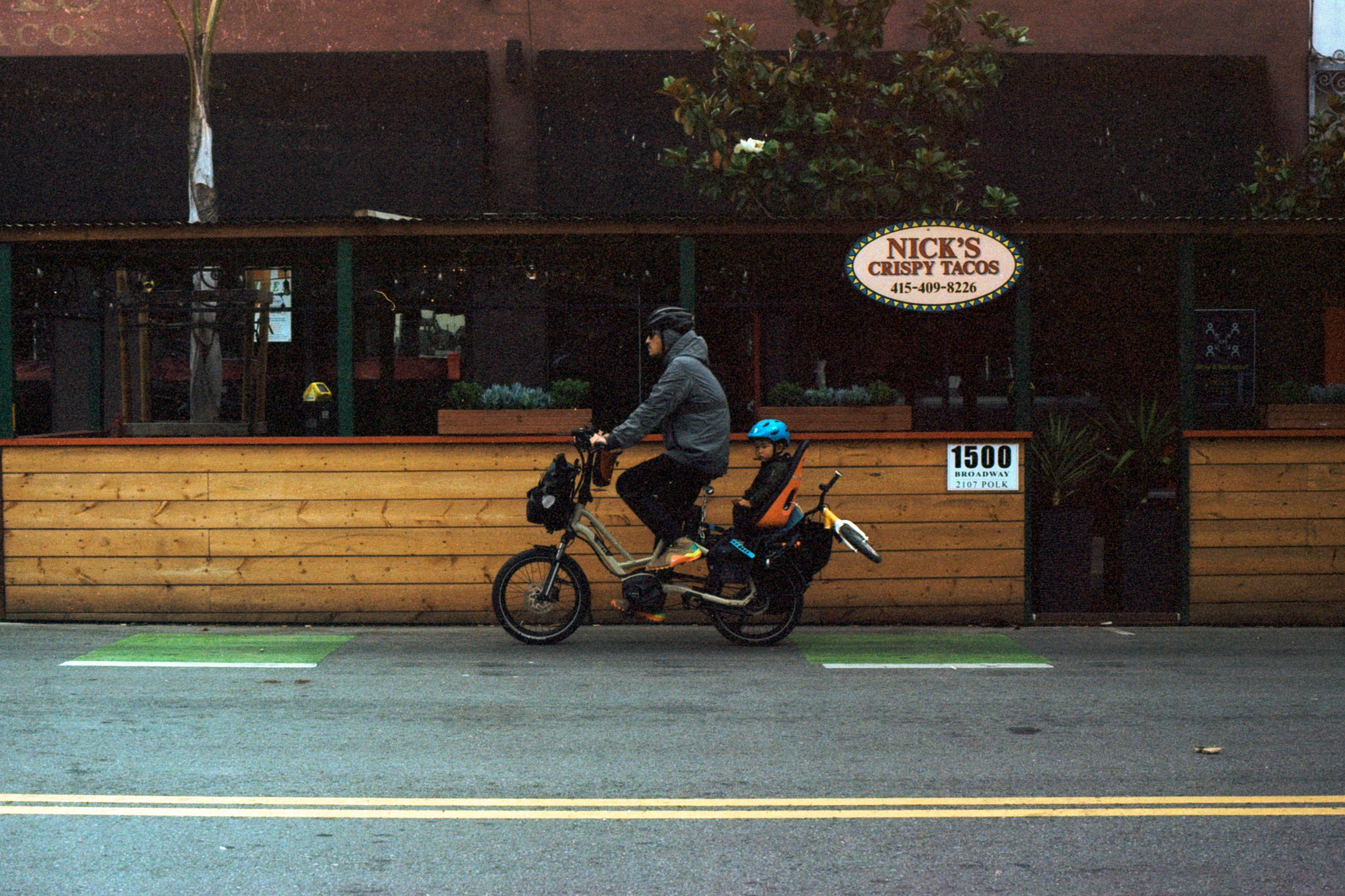 Man biking with his daughter